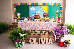 a table topped with lots of flowers next to potted plants