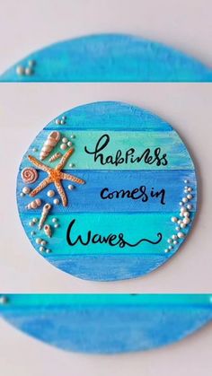 there is a blue and white sign that says happiness comes in waves with shells on it