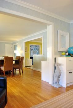 a living room filled with furniture and a wooden floor