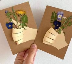 two handmade greeting cards with flowers in the middle and one holding an origami flower