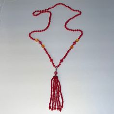 Red Beaded Tassel Necklace Detachable Tassel Necklace Measures Approx. 33” Length Tassel Measures Approx. 5” Length Makes A Great Holiday Gift Or Stocking Stuffer Elegant Red Long Beaded Necklace, Elegant Long Red Beaded Necklace, Red Tassel Necklaces As Gifts, Red Tassel Necklaces For Gifts, Red Tassel Necklace For Gift, Elegant Red Long Necklace With Round Beads, Adjustable Red Jewelry With Tassels, Adjustable Red Tasseled Jewelry, Elegant Hand-strung Red Beaded Necklaces