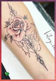 a rose tattoo on the arm is shown in black and grey colors, with an arrow around it