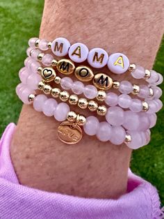 Celebrate Mom with personalized Mama stacking bracelets! Made with rose quartz gemstone beads, 14k gold filled accents, and gold charm on durable stretch elastic. You choose the bracelet style(s) and custom name personalization (Mom, Mama, Mommy, custom name). These bracelets can be worn separately or stacked together.  The perfect gift for new moms, gift for Mother's Day, Birthdays and a baby shower. Rose quartz is the stone of unconditional love. Please add each bracelet style separately to yo Pink Stackable Stretch Bracelet For Mother's Day, Pink Charm Bracelet With Letter Beads For Everyday, Pink Letter Beads Charm Bracelet For Everyday, Gold Hypoallergenic Stretch Bracelet For Mother's Day, Everyday Pink Charm Bracelet With Letter Beads, Gold Stretch Bracelet For Mother's Day, Pink Letter Beads Bracelets As Gift For Mom, Everyday Stackable Stretch Bracelet For Mother's Day, Pink Beaded Bracelet Gift For Mom With Round Beads