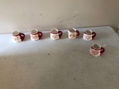 a group of coffee mugs sitting on top of a counter next to each other