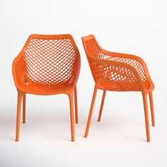 two orange chairs sitting next to each other