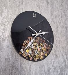 a black clock with gears on the face