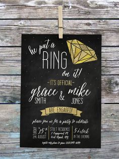 a black and gold engagement party sign hanging on a wooden wall