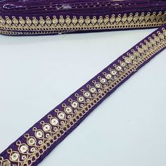 a purple belt with gold details on it