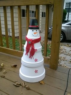 a snowman made out of plastic sitting on a porch