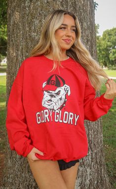 Glory Glory! Go Bulldogs! This red sweatshirt is such a classic unisex style for any UGA fan with the bulldog repping a Georgia "G" hat and the well known "Glory Glory." Mary Claire is 5'9" and is wearing size XL and medium styled sizing guide: small: 40” bust | 26” length medium: 46” bust | 27” length large: 48” bust | 28” length extra large: 50” bust | 29.5” length extra extra large: 56” bust | 31” length 50% cotton | 50% polyester WE ONLY OFFER STORE CREDIT FOR RETURNS! Feel free to email us College Gameday Outfits, Hamptons Summer, Western Tee, Red Sweatshirt, Gameday Outfit, Unisex Style, The Well, Unisex Fashion, Jumpsuit Dress