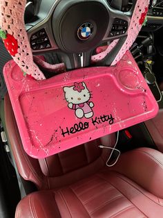 a hello kitty tray in the front seat of a car