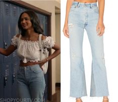 an image of a woman standing in front of lockers wearing high waisted jeans