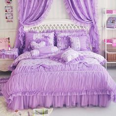 a bed with purple ruffled bedspread and pillows in a girls'bedroom