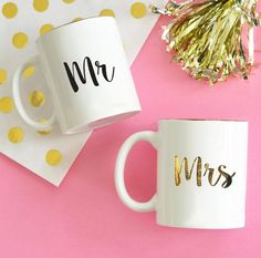 two coffee mugs with mr and mrs written on them next to confetti