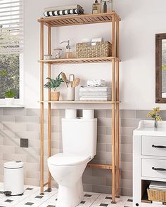 a white toilet sitting in a bathroom next to a shelf filled with towels and other items