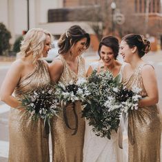 bridesmaids in gold sequin dresses holding bouquets and smiling at each other