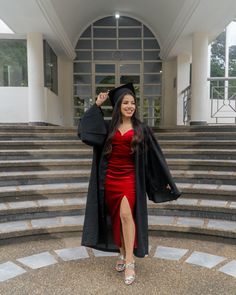 a woman in a graduation gown is posing for the camera