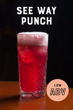 a red drink sitting on top of a table next to a black background with the words see way punch