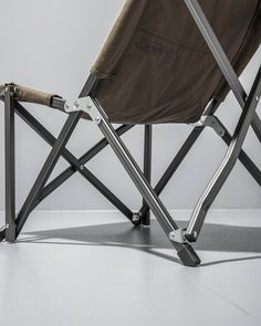 a folding chair sitting on top of a white floor