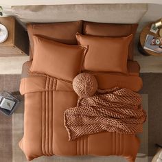 an overhead view of a bed with brown sheets and pillows