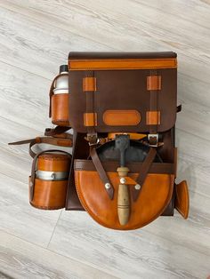 an overhead view of a brown and tan leather bag with its contents neatly packed in it