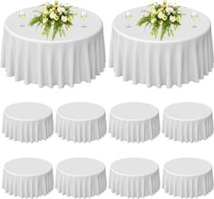 a bunch of tables with white tablecloths and flowers on them, all in different positions