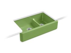 a green sink with two faucets on the side and one in the middle