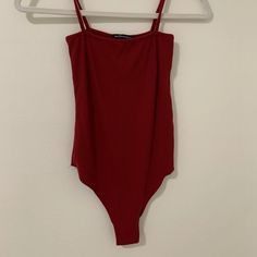 In Brand New Condition Soft And Comfortable Brandy Melville Red Brandy Melville, Brandy Melville Number Tee, Brandy Melville Eye Tank Top, Brandy Melville Beyonca Tank, Brandy Melville Striped Zelly Top, Red Bodysuit, Brandy Melville Tops, Brandy Melville, Brandy