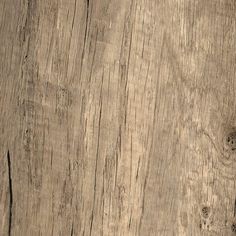 an old wooden surface with peeling paint on the edges and wood grains that have been stripped off