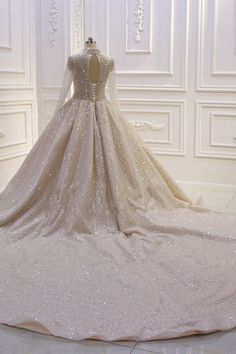 a wedding dress on display in a white room