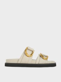 It does not get any more iconic than this: our Gabine slide sandals receive a L'initial update with a distinctive twist. The iconic U-shaped buckles are now etched with our C&K emblem for an extra touch of elegance. Set against the soft chalk leather uppers, the gold-tone buckles seamlessly complement the timeless design, making them instantly recognisable even from afar. Resting on cushioned, ergonomic footbeds, these sandals promise the utmost comfort and style. Belt Ring, Charles Keith, Leather Slides, Belt Size, Slide Sandals, Sales Gifts, Trending Shoes, Comfortable Shoes, Kids Shoes