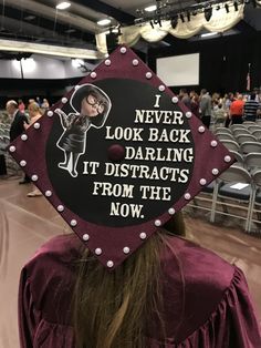 a graduation cap that says i never look back daring it distracts from the now