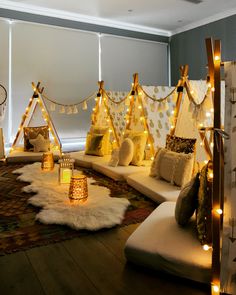 a living room filled with lots of pillows and lights