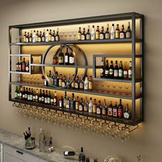 a wall mounted shelf filled with lots of bottles and glasses on top of a counter