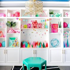 a living room filled with lots of colorful furniture and decor on top of bookshelves