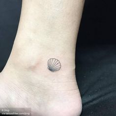 a small seashell tattoo on the ankle