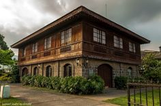 an old wooden building with lots of windows and balconies on the top floor