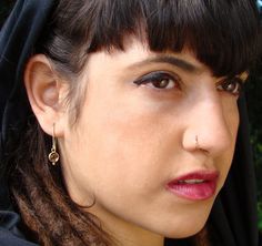 a close up of a person wearing earrings