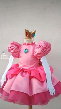 a pink dress with a gold crown on top