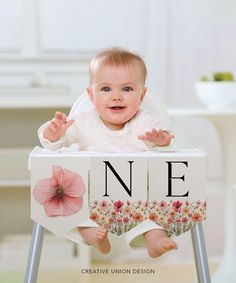 a baby sitting in a high chair with the letter n on it's back