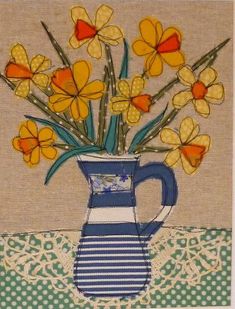 a painting of yellow flowers in a blue and white striped vase on a table cloth