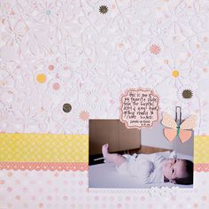 a scrapbook page with a baby laying on it's side and an image of a butterfly