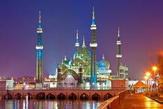 an image of a building that is lit up in the night time with lights on it