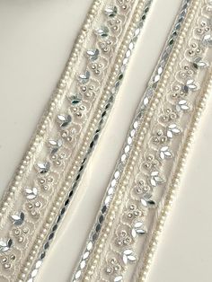 The embroidered Pearl zircon White ribbon with real mirror can be used by itself or teamed up with other laces and will still stand out. Perfect for blouse, sari, suits, traditional wear, Dupattas , kaftans  We are constantly adding new items and you will be sure to find our complete inventory with 1000's of designs at www.lacetrimssindia.com PLEASE NOTE : ALL ORDERS ARE SHIPPED FROM THE INDIA RETURN POLICY *All broken case can be re-sent or refund if the condition is proven by photo . *Exchange Beaded White Bridal Belt For Party, White Beaded Bridal Belt For Party, Silver Bridal Belt With Pearl Embroidery, Silver Bridal Belt With Pearl Embroidery For Wedding, Silver Lace Bridal Accessories For Wedding, Elegant Embroidered Bridal Belt For Wedding, Elegant Lace Trims For Wedding, Elegant Embellished Trims For Wedding, Elegant Embroidered Wedding Trims