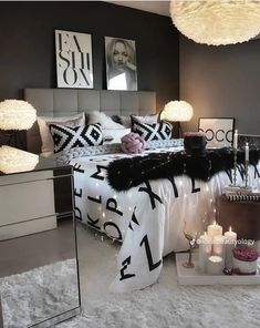 a bedroom decorated in black and white with candles