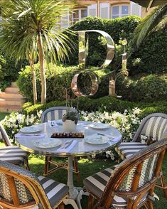 an outdoor table and chairs in the grass