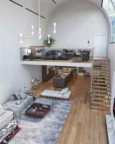 a living room filled with furniture next to a stair case on top of a hard wood floor