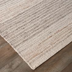 the textured rug is on top of a wooden floor, and it looks like it has