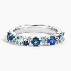 a white gold ring with blue stones and diamonds