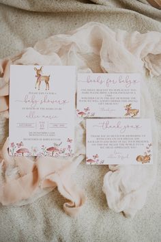 the wedding stationery is laid out on the bed